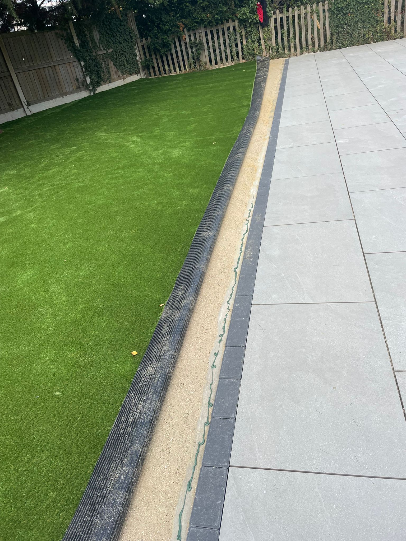 Artificial grass edge with paving border