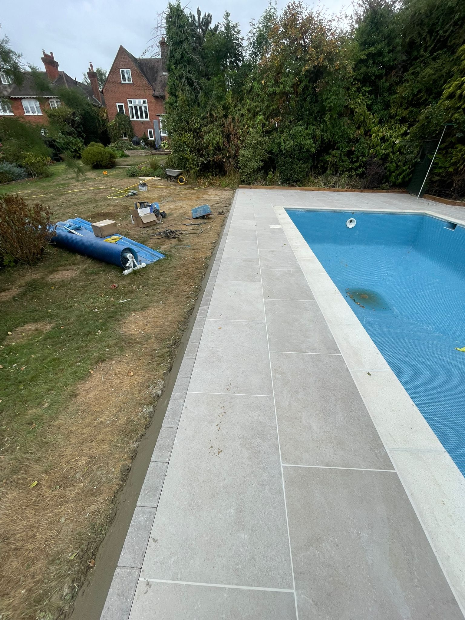 Pool edge paving with grass border