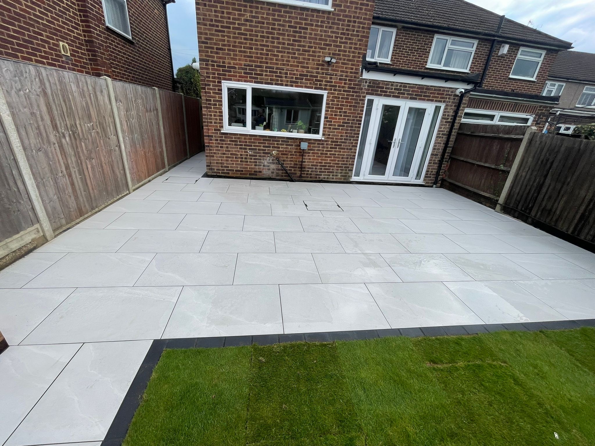 Porcelain patio with fresh lawn
